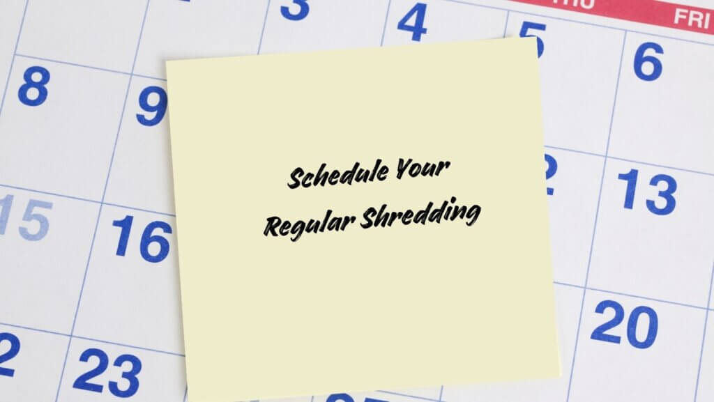 A calendar with a sticky note that says "Schedule Your Regular Shredding"